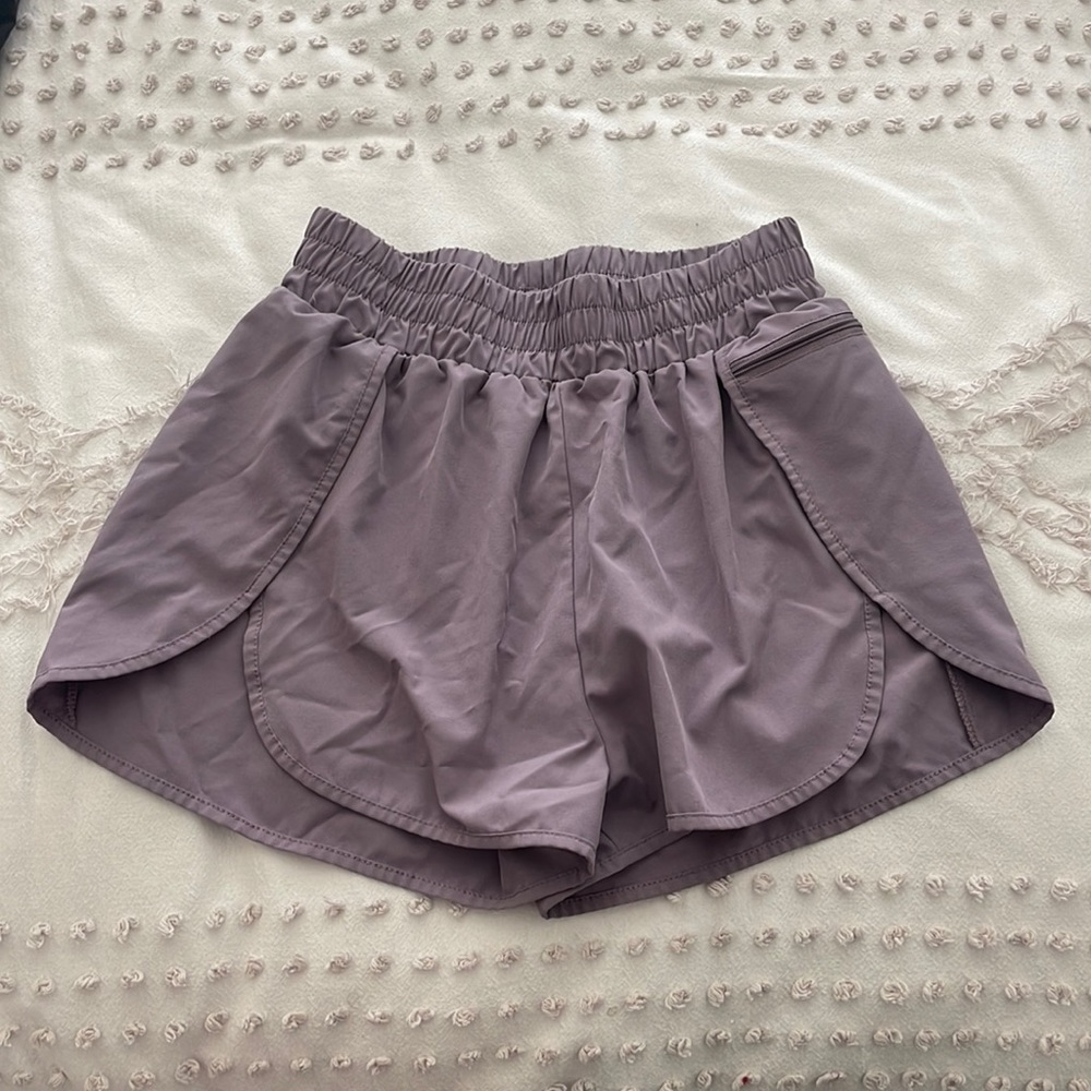 Purple athletic shorts with a pocket
